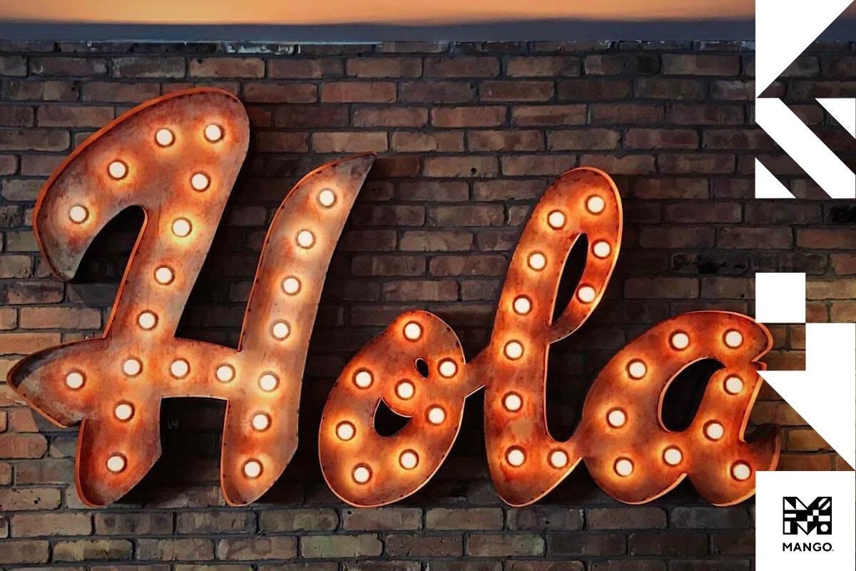 A lit-up sign with the word "Hola"