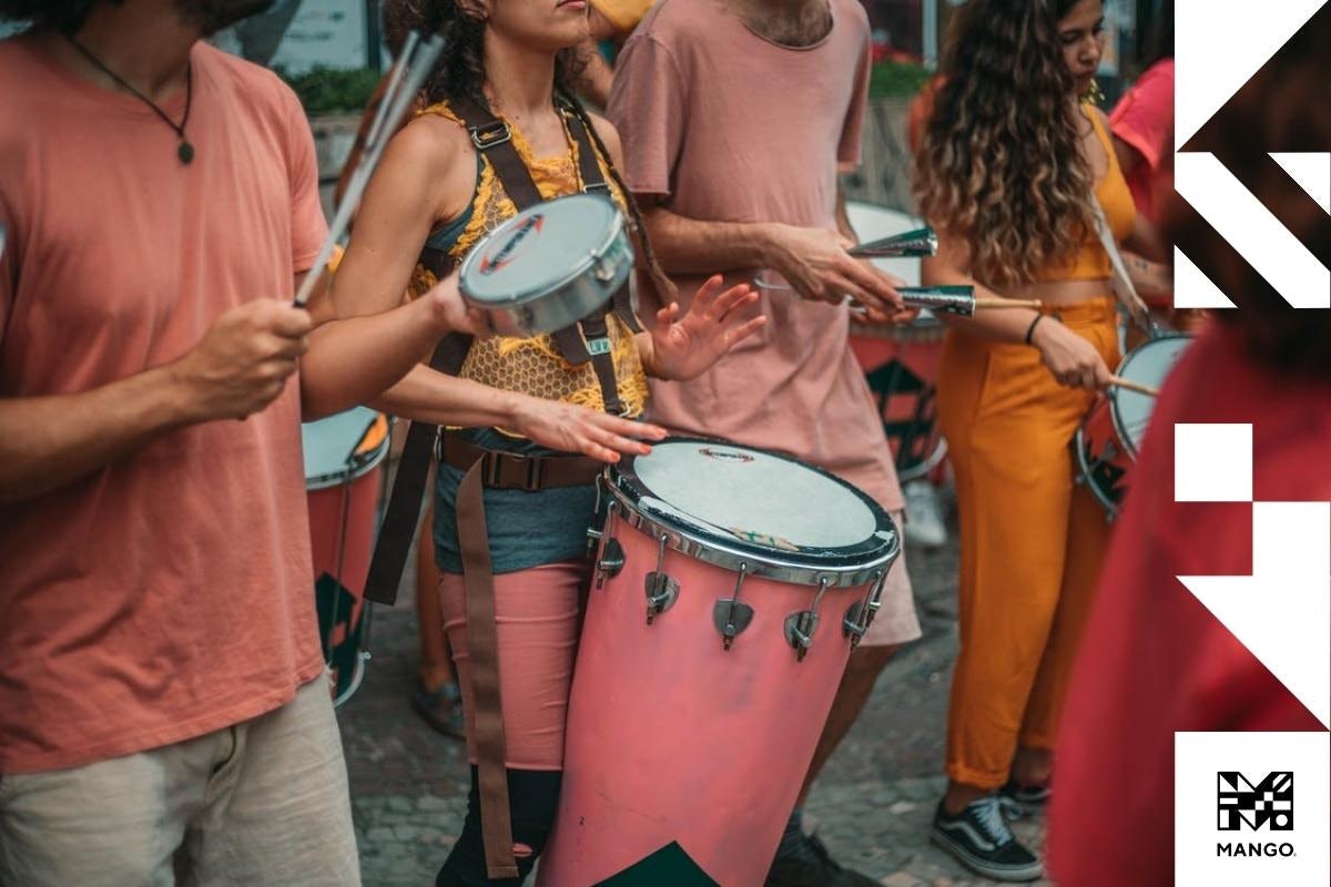 People playing percussion instruments in the middle of a street